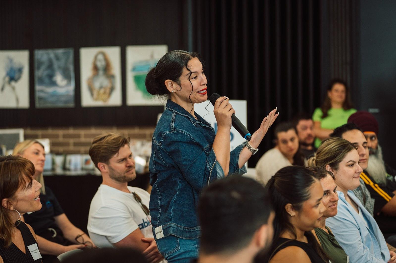 Yosmerys Aparicio Cuencas speaking at a community event, Youth Independence Leader and Founder of Supporting Communities Australia